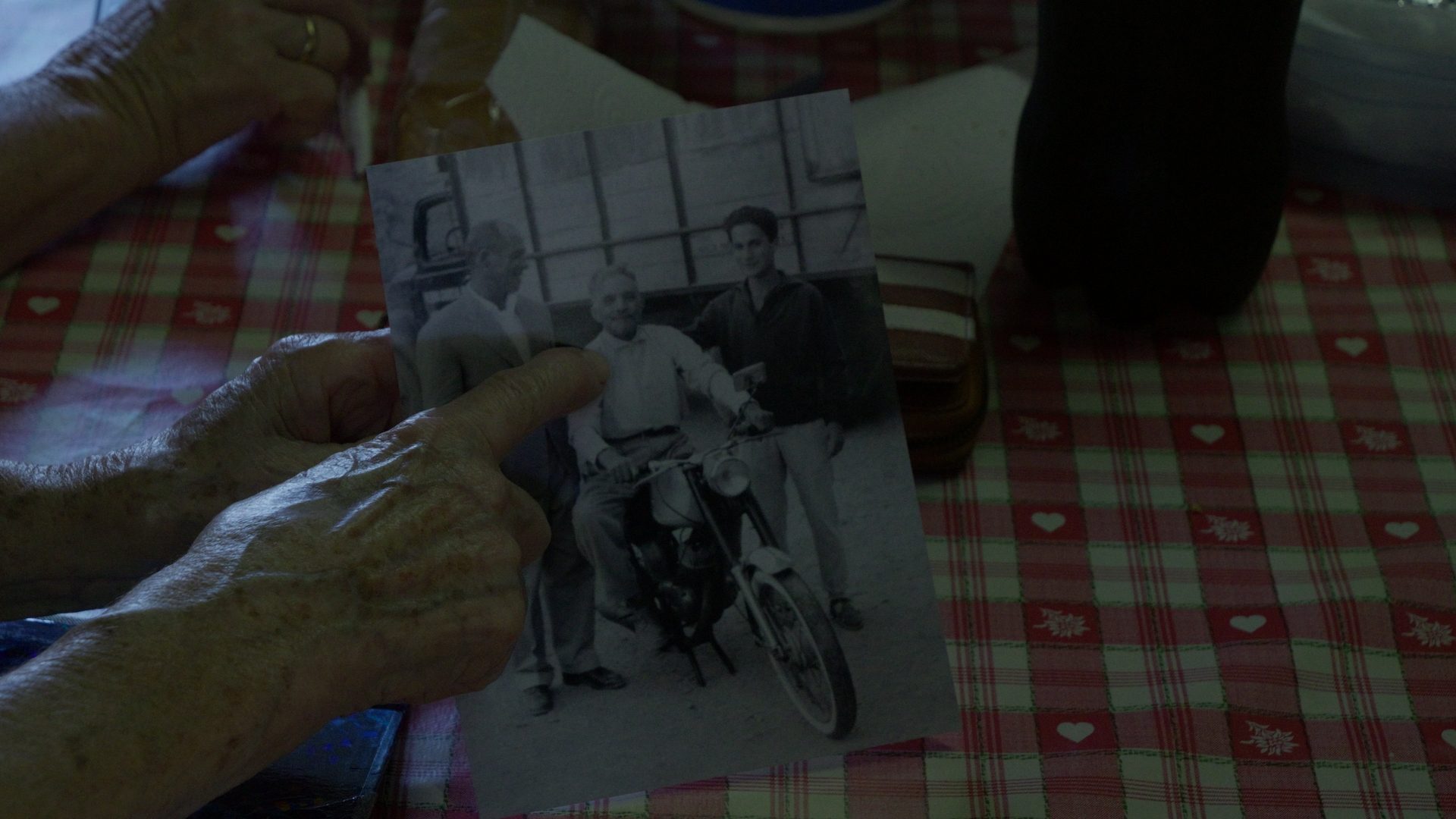 Hands holding an old black-and-white family photograph — Discovering Icor