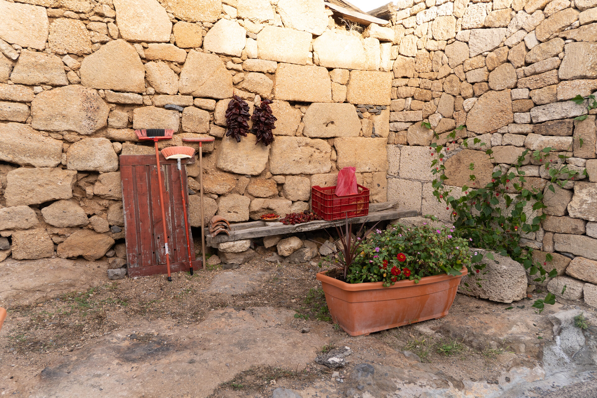 Stone wall of Icor with peppers drying in the sun