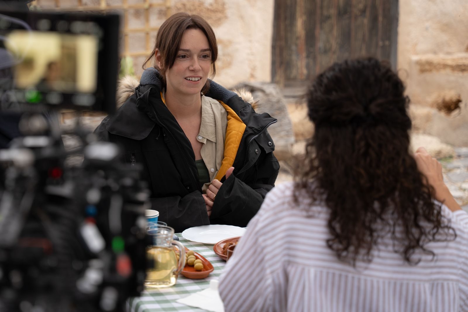 Alexandra Essoe in a scene of The Silenced, at an outdoor table